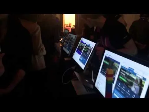 Video: the audience crowded around contestants' monitors in a darkened room during the competition
